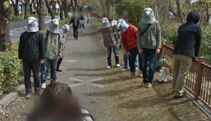 people wearing pigeon masks near the Tamagawa Aqueduct